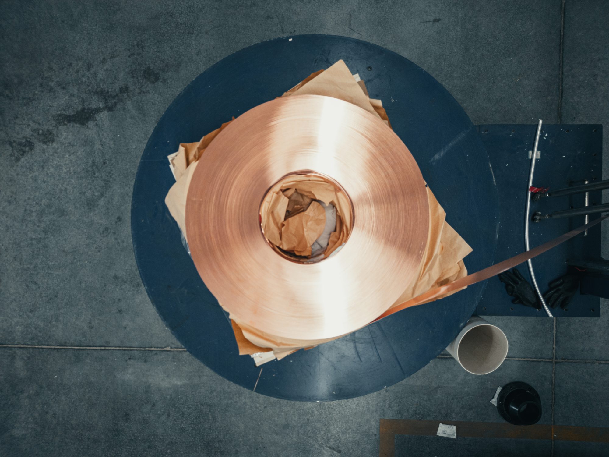 Top-down view of a copper strip coil feeding the cladding process