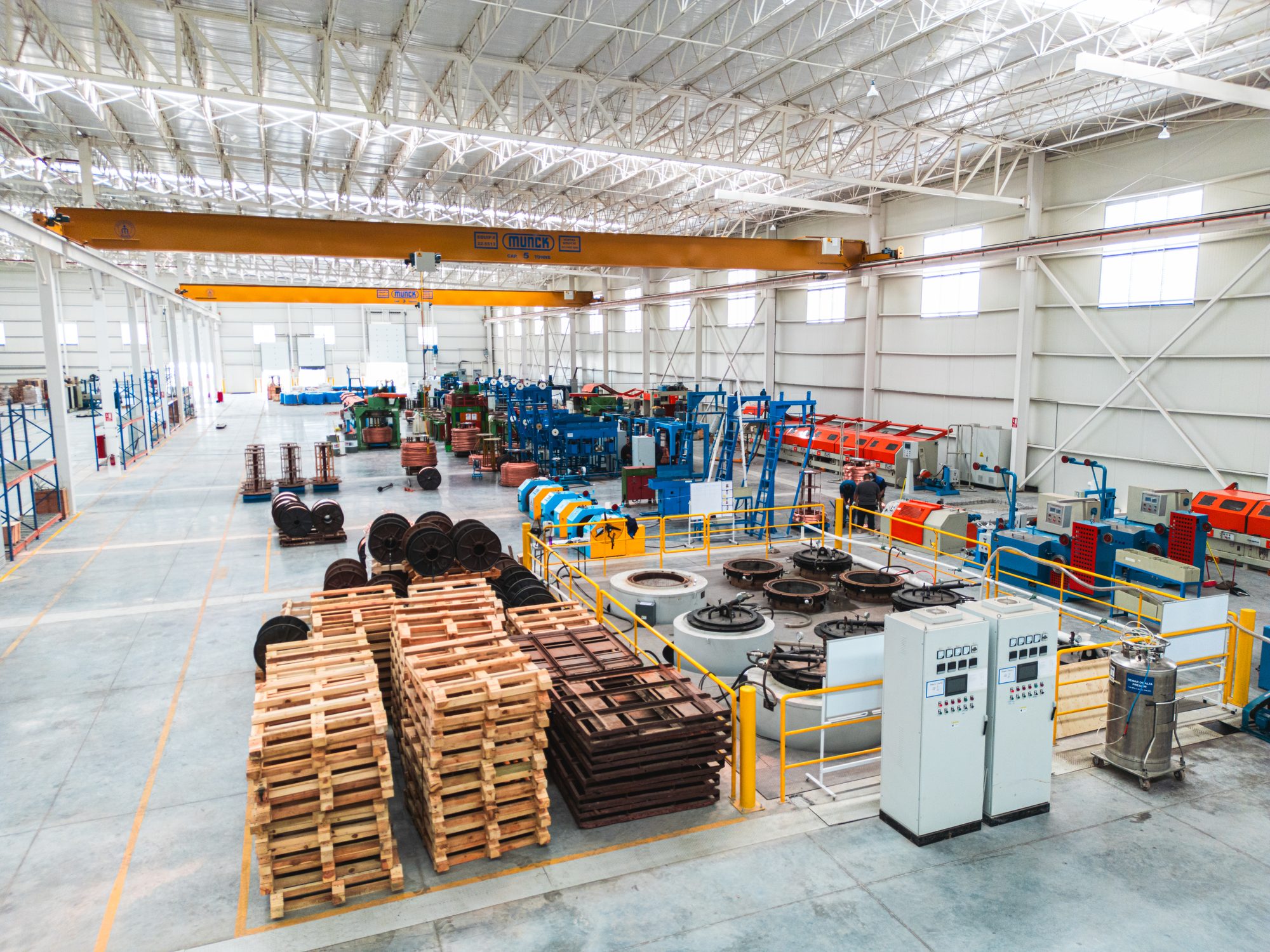 Overview of the production floor with drawing, cladding, and finishing lines under overhead cranes
